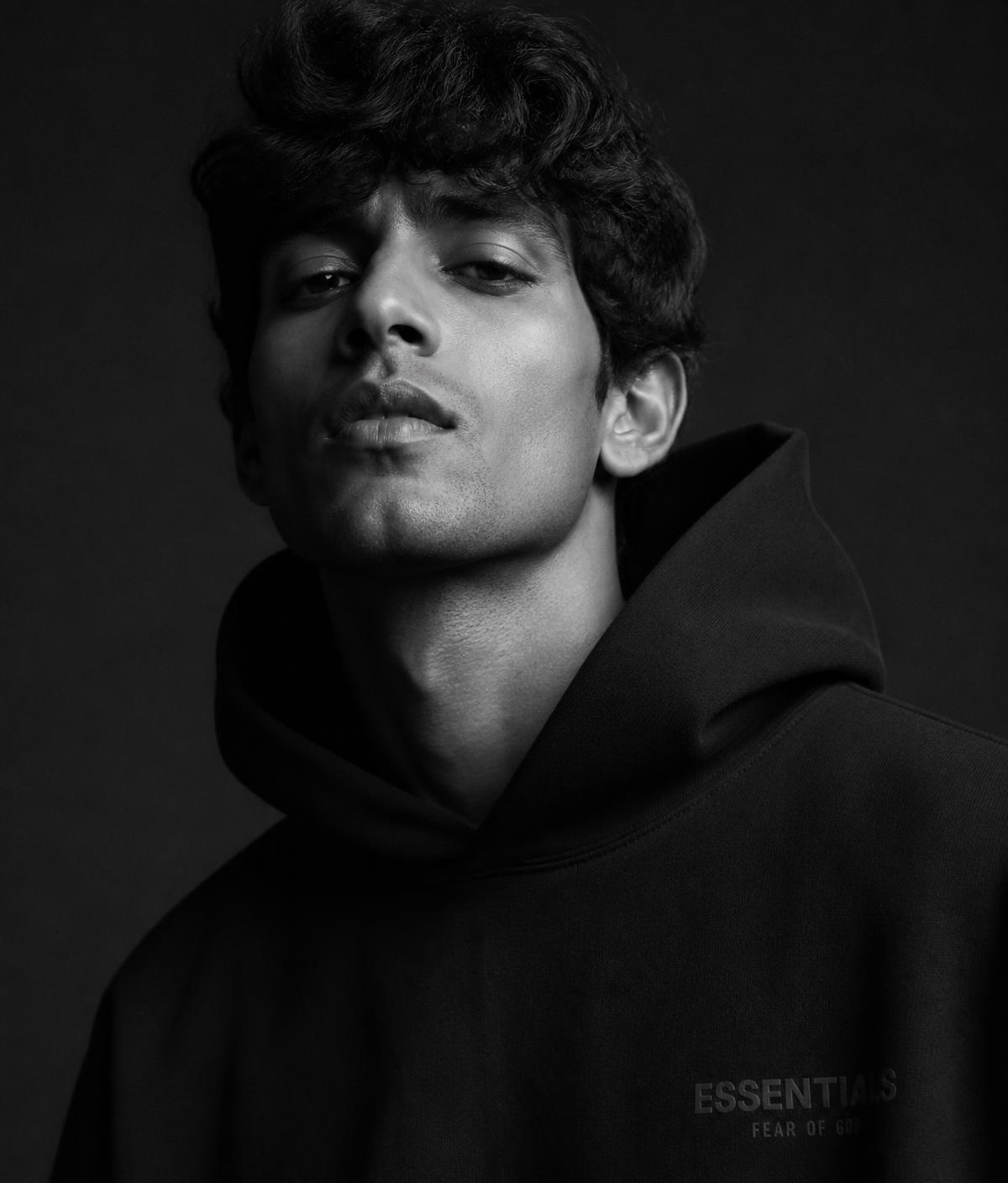 Model wearing an Aurel hoodie in dramatic monochrome light